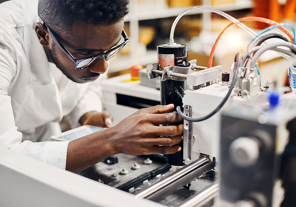 Man working on a machine in a lab.