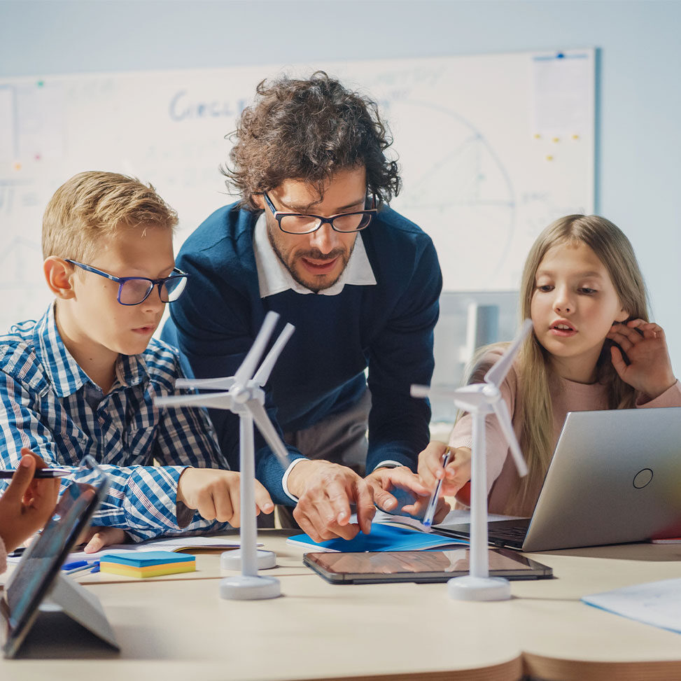 Elementary school teacher in a classroom with students.